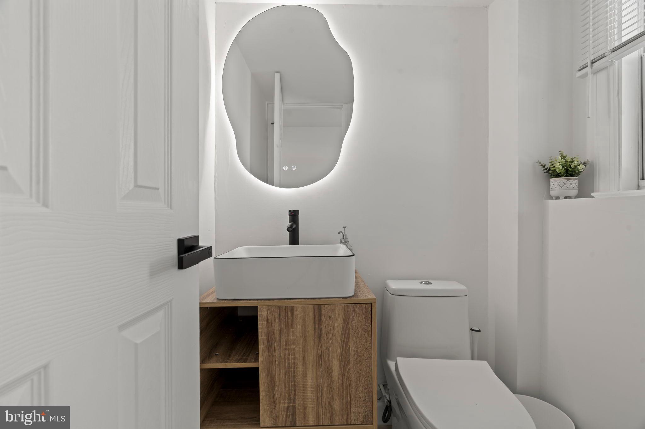 209 Front Street Mount Holly, NJ 08060 - Photo 22 of 35 a bathroom with a toilet a sink and a mirror