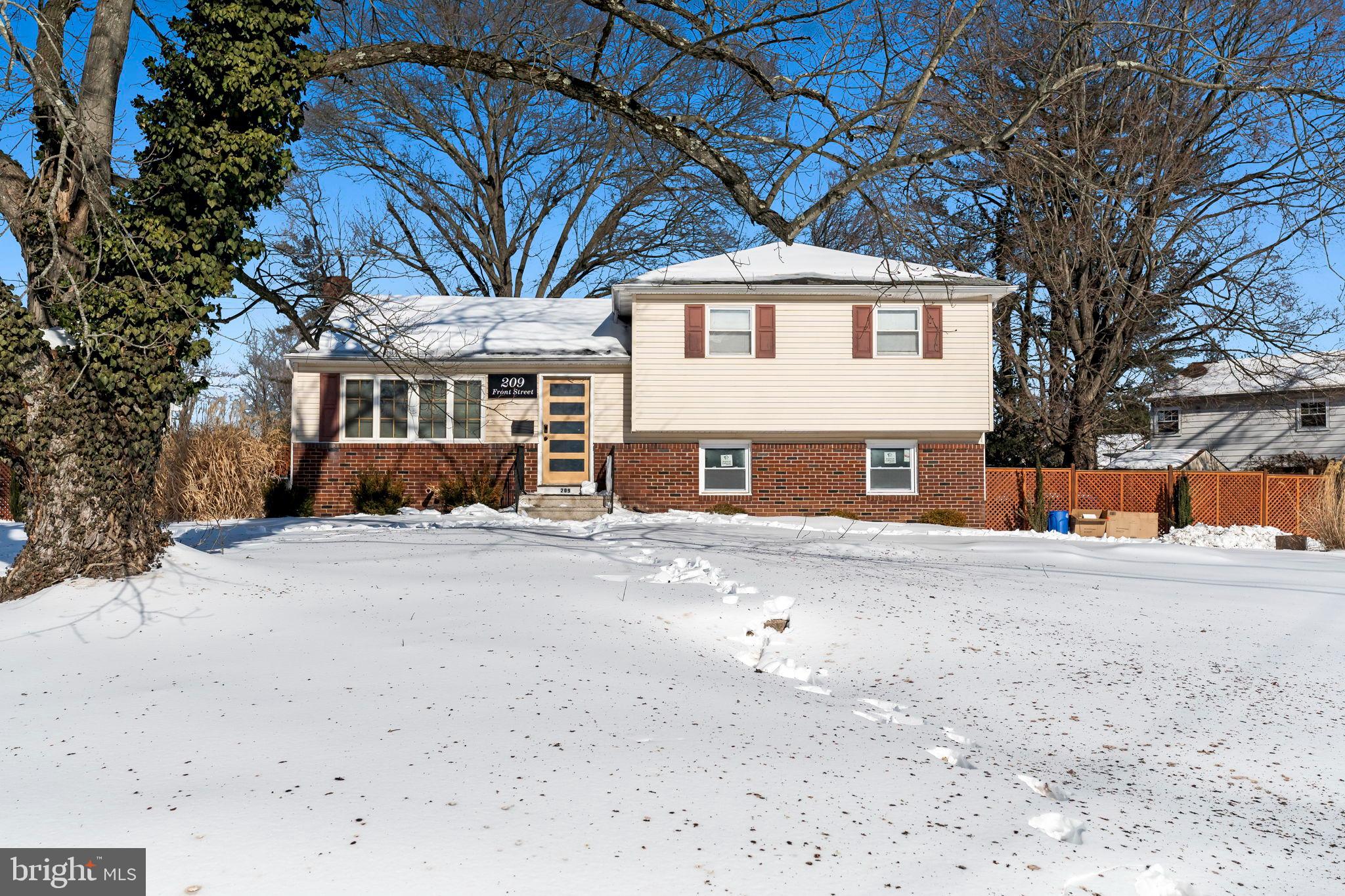 209 Front Street Mount Holly, NJ 08060 - Photo 3 of 35 a front view of a house with a large tree in front