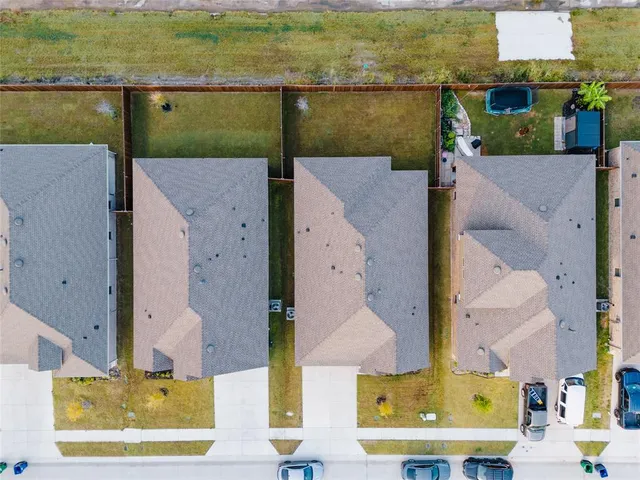 an aerial view of residential houses with outdoor space