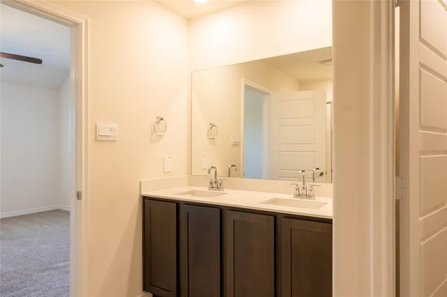 a bathroom with a double vanity sink and a mirror