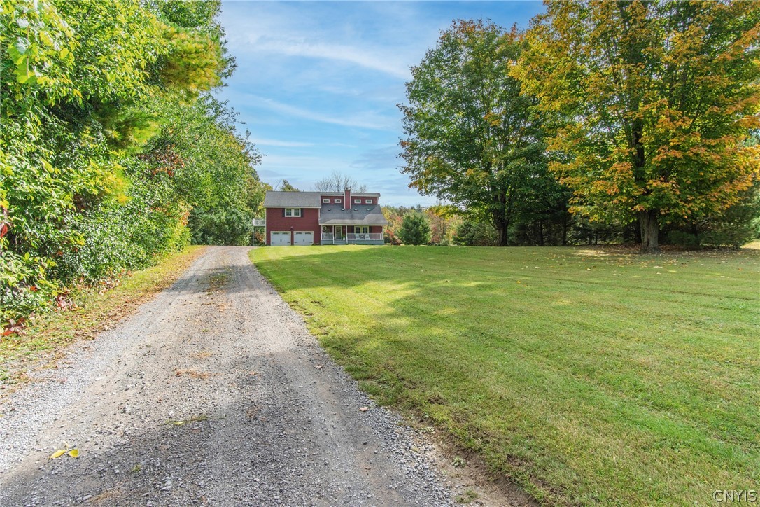 15384 Fuller Road Adams, NY 13606 - Photo 6 of 50 A long gravel driveway leads to this charming red home nestled among mature trees.
