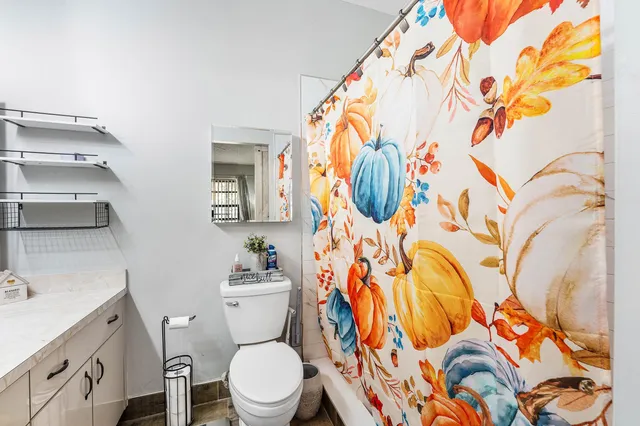 a white toilet sitting next to a bathroom sink