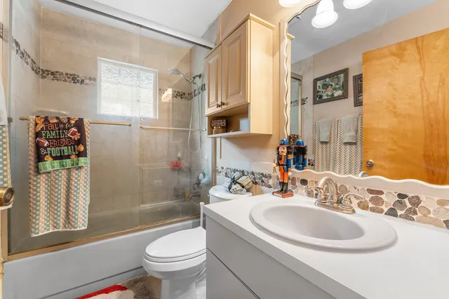 a bathroom with a sink toilet and shower