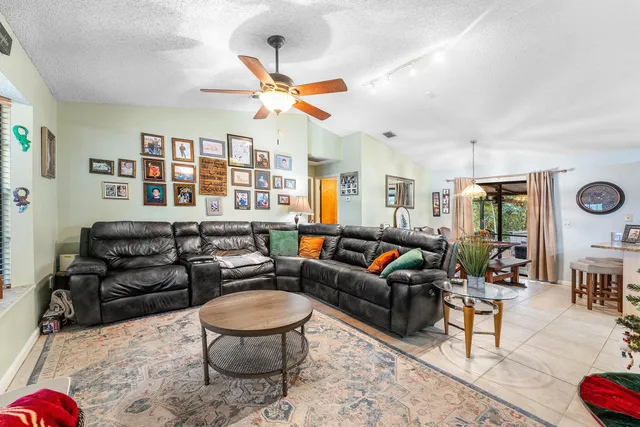 a living room with furniture a dining table and chairs