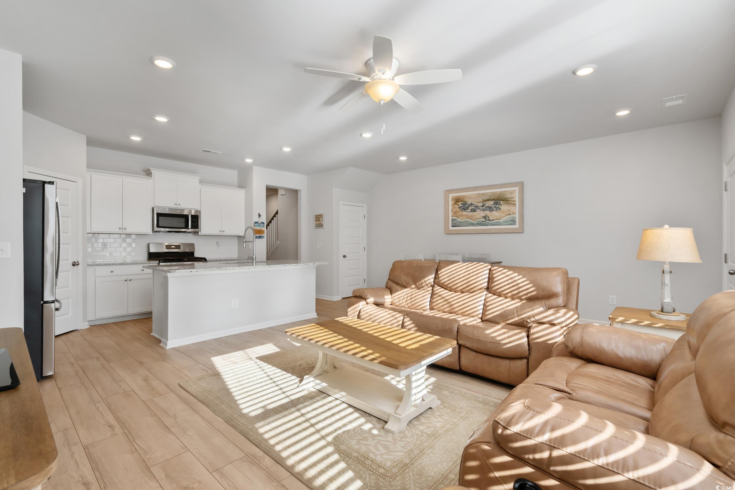 5371 Knobcone Loop, Unit B Myrtle Beach, SC 29577 - Photo 12 of 40 Living room with ceiling fan and light hardwood /