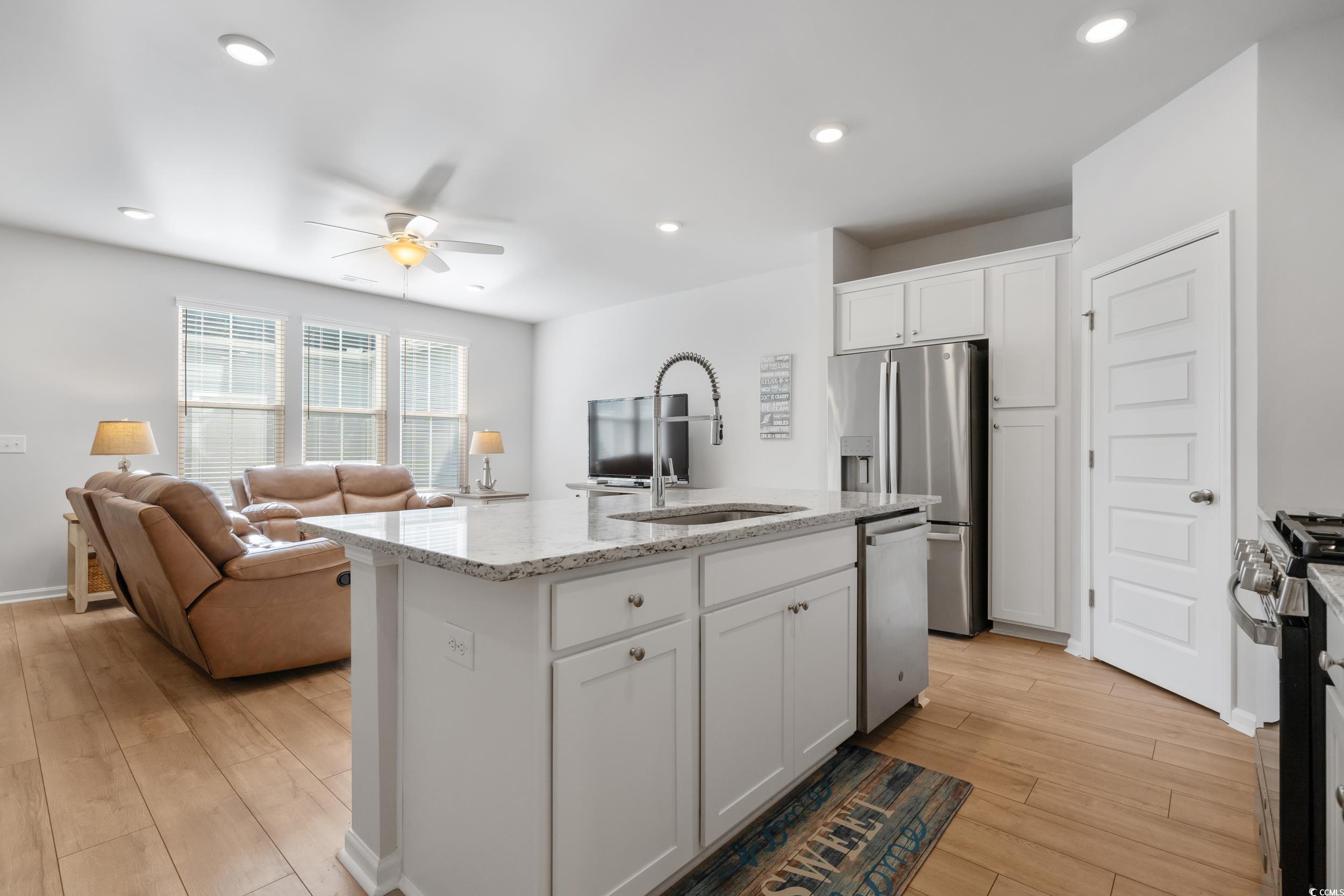 5371 Knobcone Loop, Unit B Myrtle Beach, SC 29577 - Photo 16 of 40 Kitchen featuring a kitchen island with sink, ceil