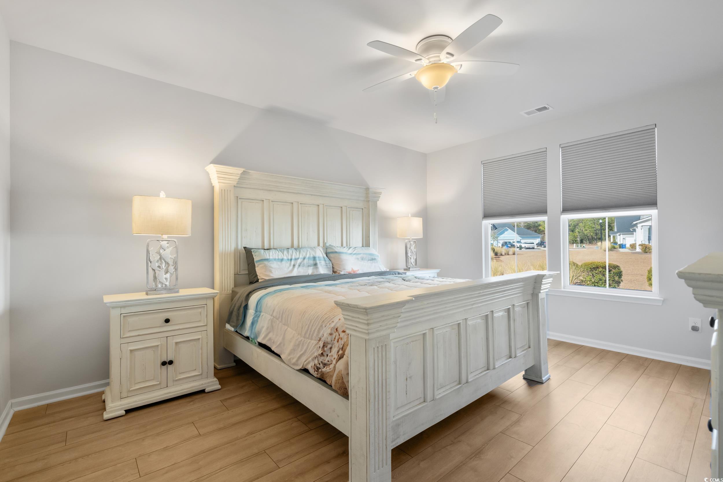 5371 Knobcone Loop, Unit B Myrtle Beach, SC 29577 - Photo 19 of 40 Bedroom featuring ceiling fan and light hardwood /