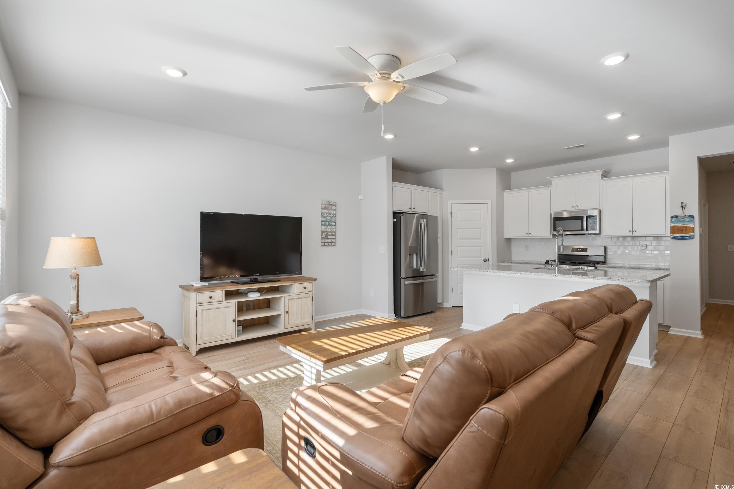 5371 Knobcone Loop, Unit B Myrtle Beach, SC 29577 - Photo 9 of 40 Living room with ceiling fan and light wood-type f