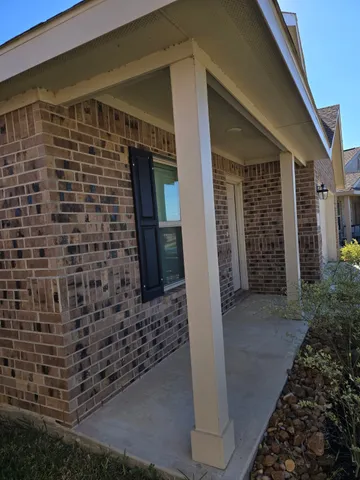 a view of a brick house with an outdoor space