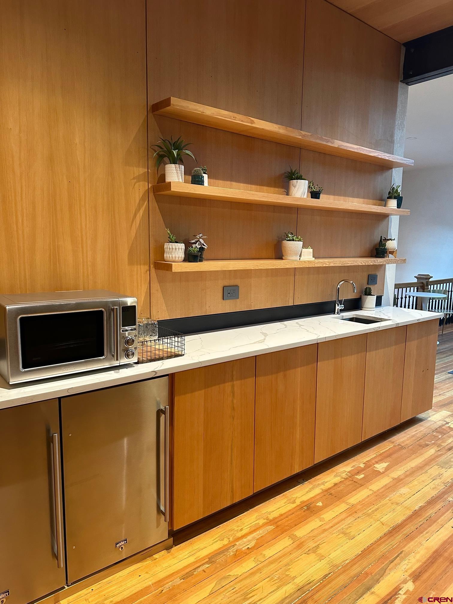 813 Main Avenue, Unit 304 Durango, CO 81301 - Photo 12 of 20 a kitchen with wooden cabinets and sink