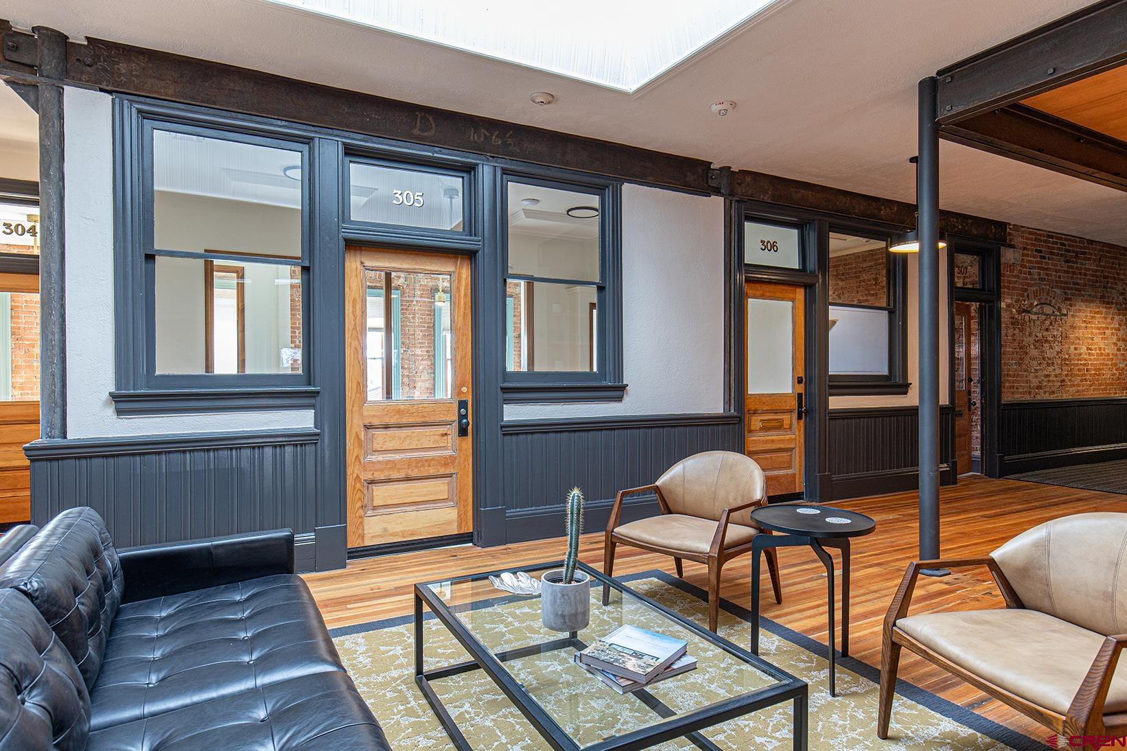 813 Main Avenue, Unit 304 Durango, CO 81301 - Photo 17 of 20 a living room with furniture and floor to ceiling window