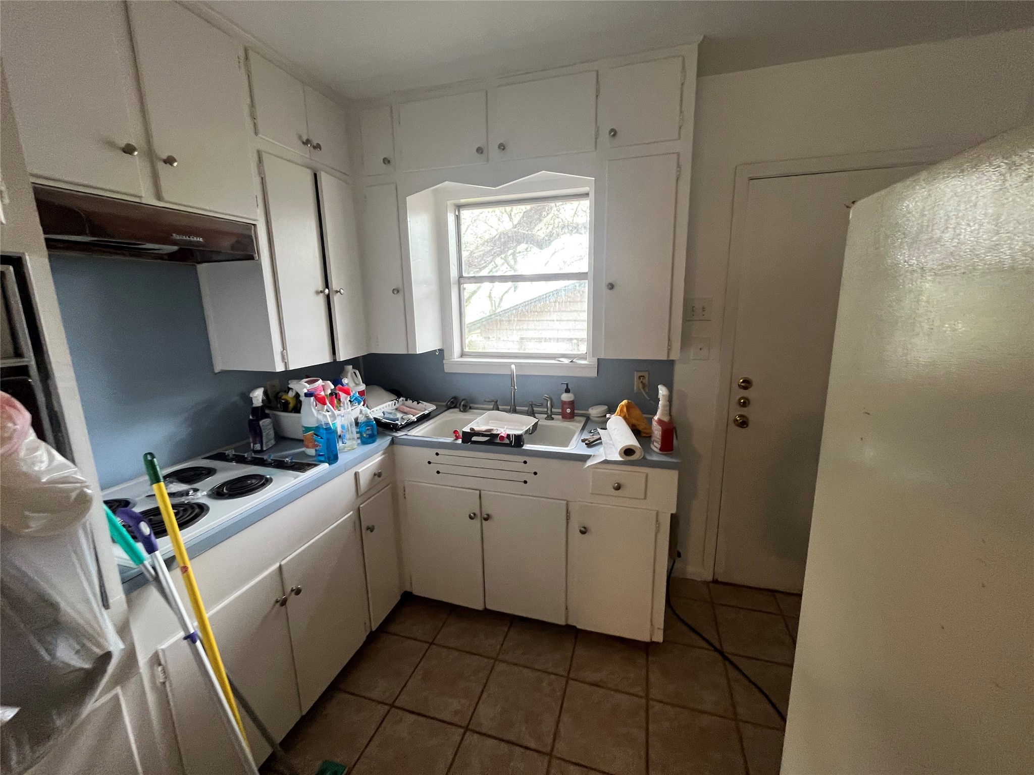 1607 Lightsey Road, Unit A Austin, TX 78704 - Photo 7 of 17 Kitchen with white cabinetry, a double basin sink, and a built-in electric range