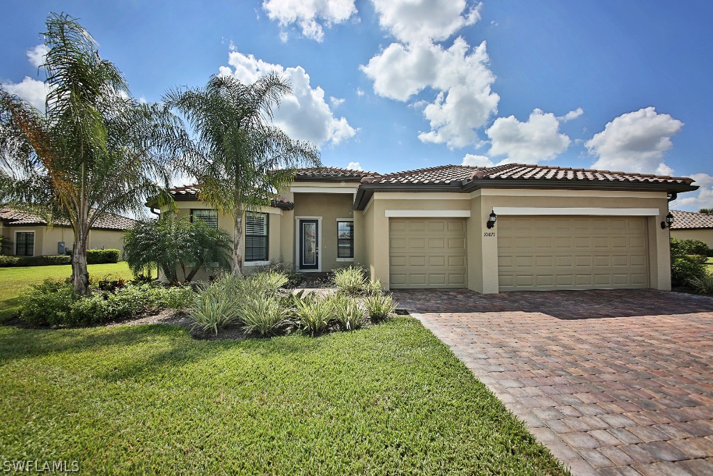 10871 Rutherford Road Fort Myers, FL 33913 - Photo 1 of 25 a front view of a house with garden