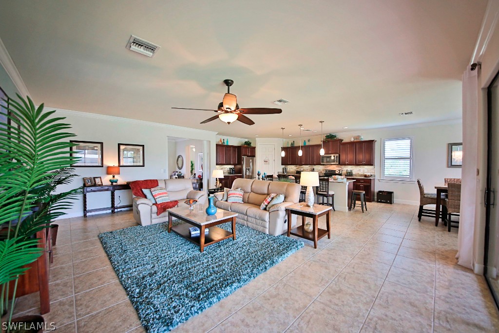 10871 Rutherford Road Fort Myers, FL 33913 - Photo 8 of 25 a living room with lots of furniture kitchen view and a rug