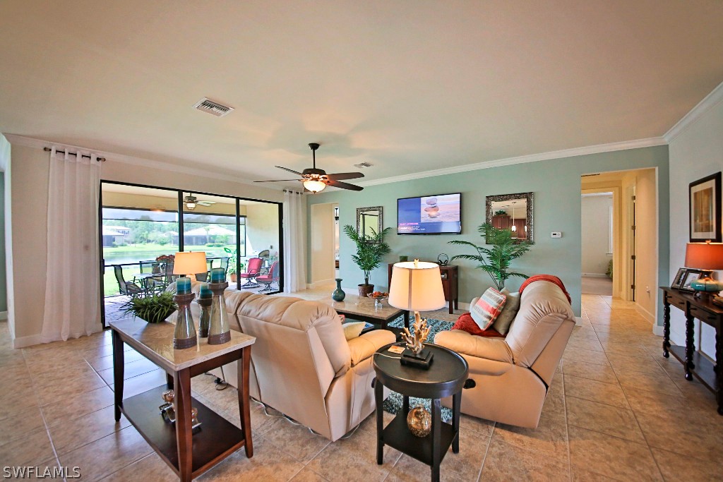 10871 Rutherford Road Fort Myers, FL 33913 - Photo 9 of 25 a living room with furniture a flat screen tv and a large window