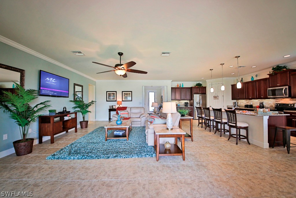 10871 Rutherford Road Fort Myers, FL 33913 - Photo 10 of 25 a living room with furniture and a flat screen tv