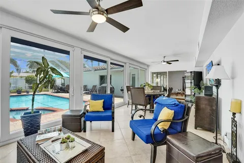 a living room with furniture and a floor to ceiling window