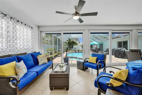 a living room with furniture ceiling fan and a rug
