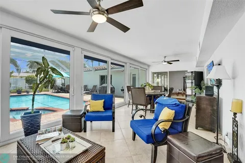 a living room with furniture a ceiling fan and a rug