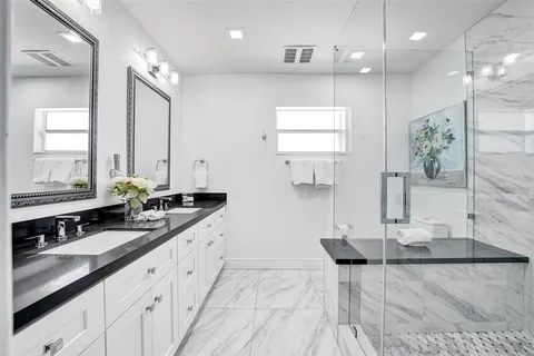 a large kitchen with a sink and cabinets