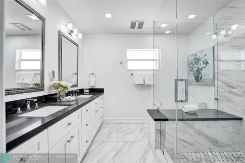a en suite bathroom with double sink and a mirror