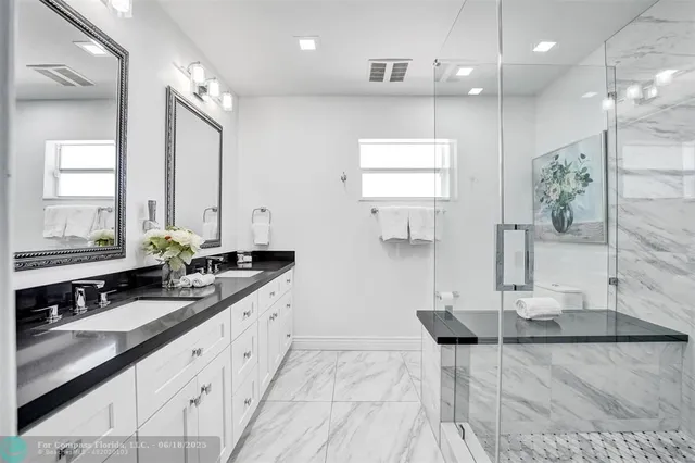 a en suite bathroom with double sink and a mirror