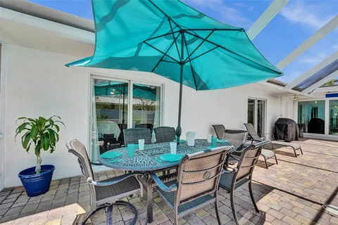 a view of an outdoor sitting area with furniture and umbrella