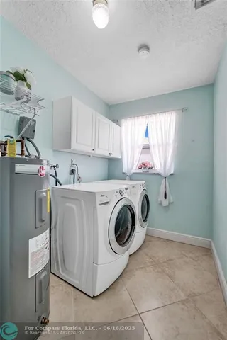 a view of a patio with couches table and chairs under an umbrella