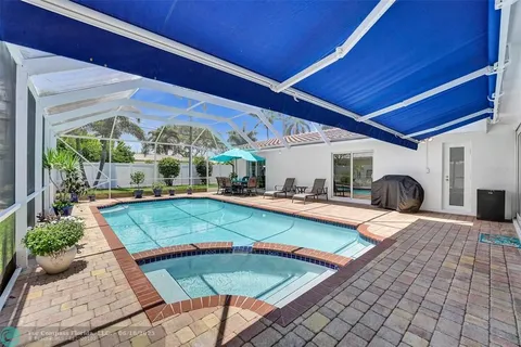 a view of an outdoor sitting area with furniture and umbrella