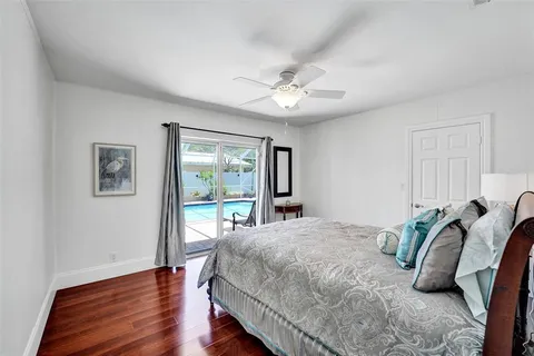 a bedroom with a bed ceiling fan and a window