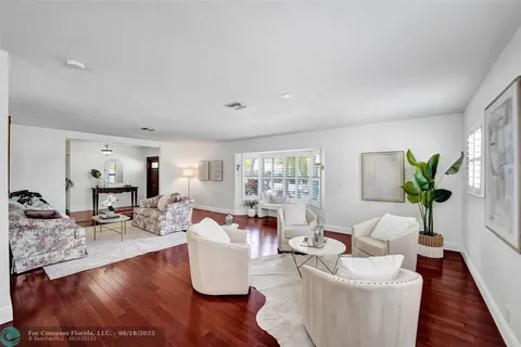 a living room with fireplace furniture and a wooden floor