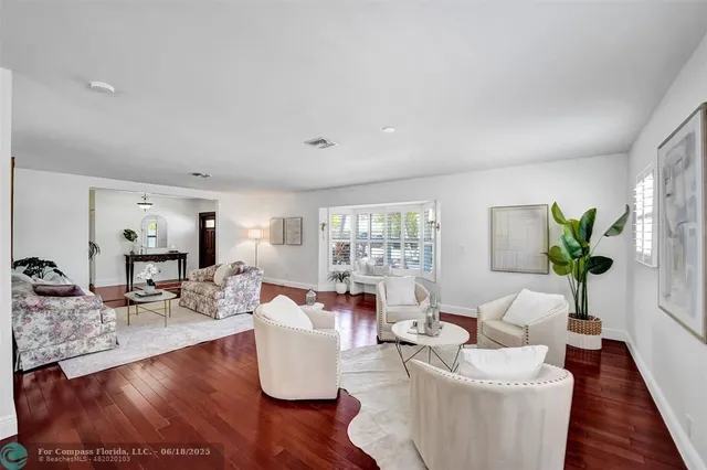 a living room with fireplace furniture and a wooden floor