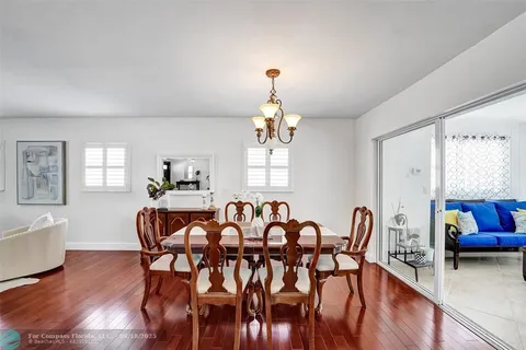 a view of a a dining room with furniture window and wooden floor