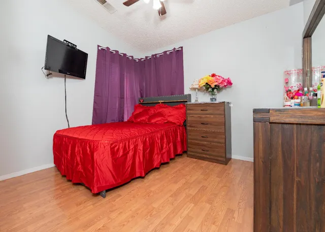 a bedroom with a bed and a flat screen tv