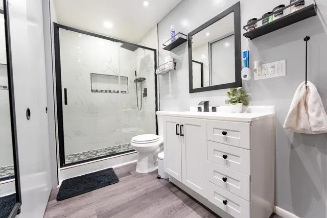 a bathroom with a sink mirror toilet and shower