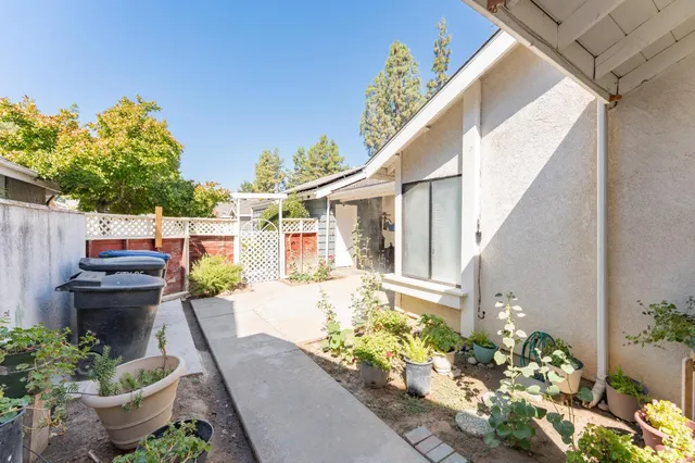 a view of a house with potted plants