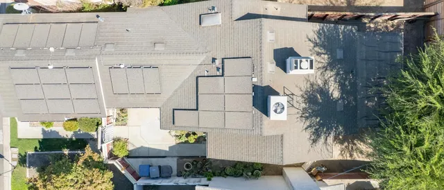 a front view of a house with outdoor seating and plants