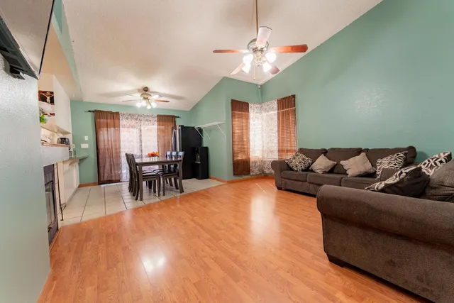 a living room with furniture and kitchen view