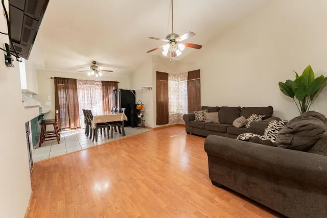 a living room with furniture and a chandelier
