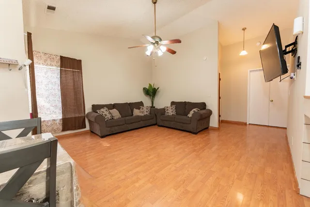 a living room with furniture and a chandelier