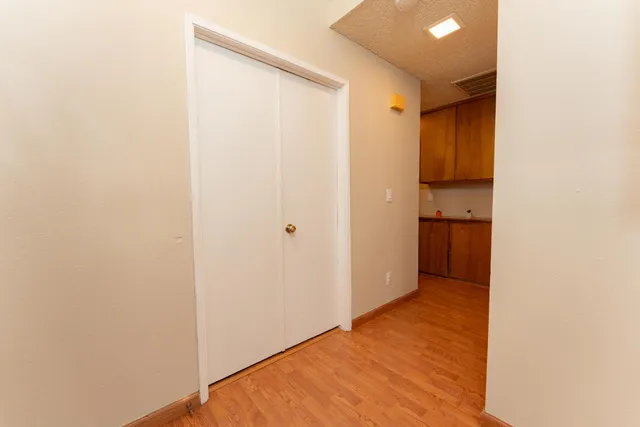 a view of a hallway with wooden floor