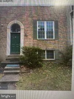 a front view of a house with plants