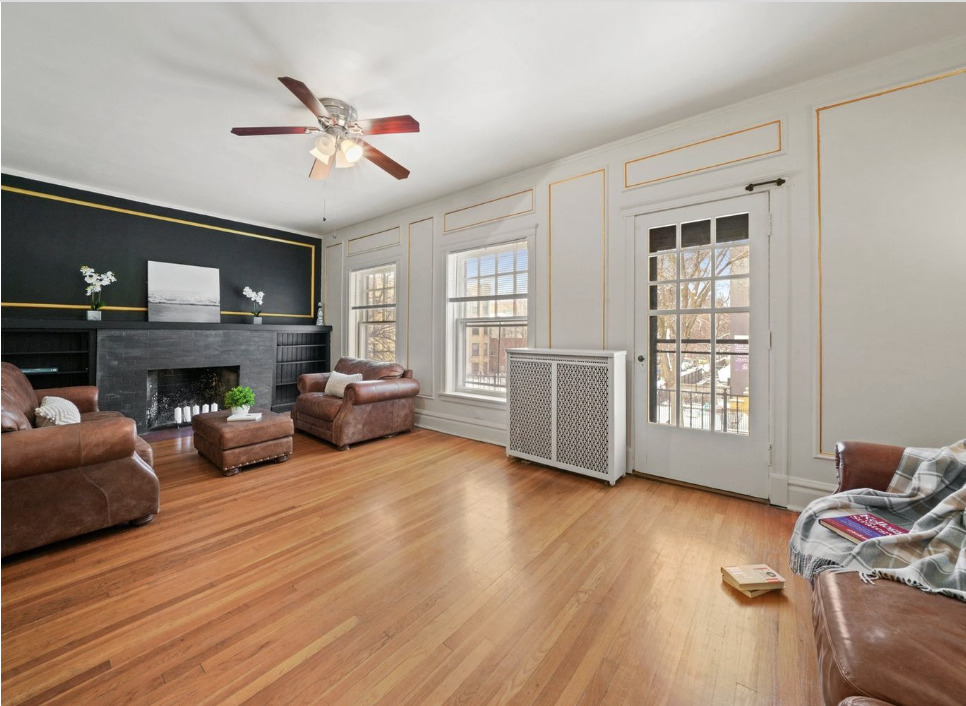 1067 West Balmoral Avenue, Unit 2 Chicago, IL 60640 - Photo 3 of 15 a living room with furniture and a fireplace