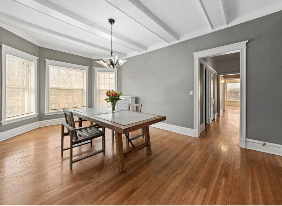 1067 West Balmoral Avenue, Unit 2 Chicago, IL 60640 - Photo 5 of 15 a dining room with wooden floor a chandelier a wooden table and chairs