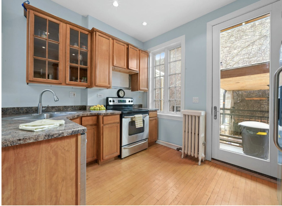 1067 West Balmoral Avenue, Unit 2 Chicago, IL 60640 - Photo 7 of 15 a kitchen that has a sink and a stove