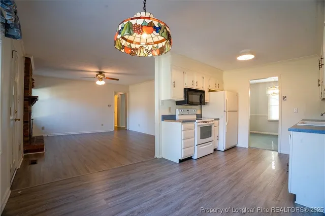 a view of a kitchen with a sink stainless steel appliances and cabinets