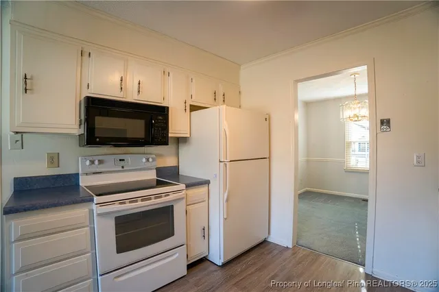 a kitchen with a refrigerator stove and microwave