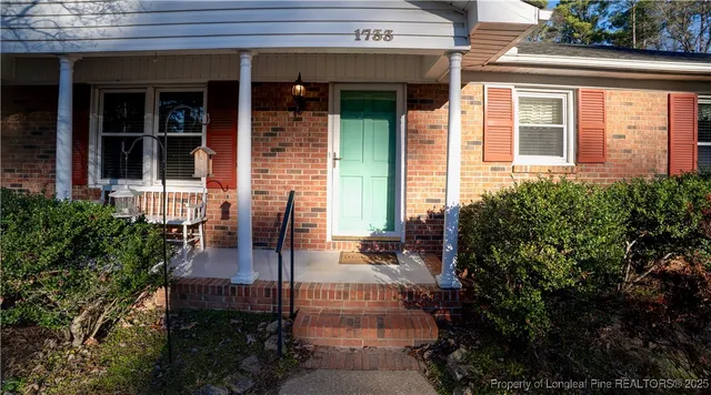 a front view of a house with outdoor seating