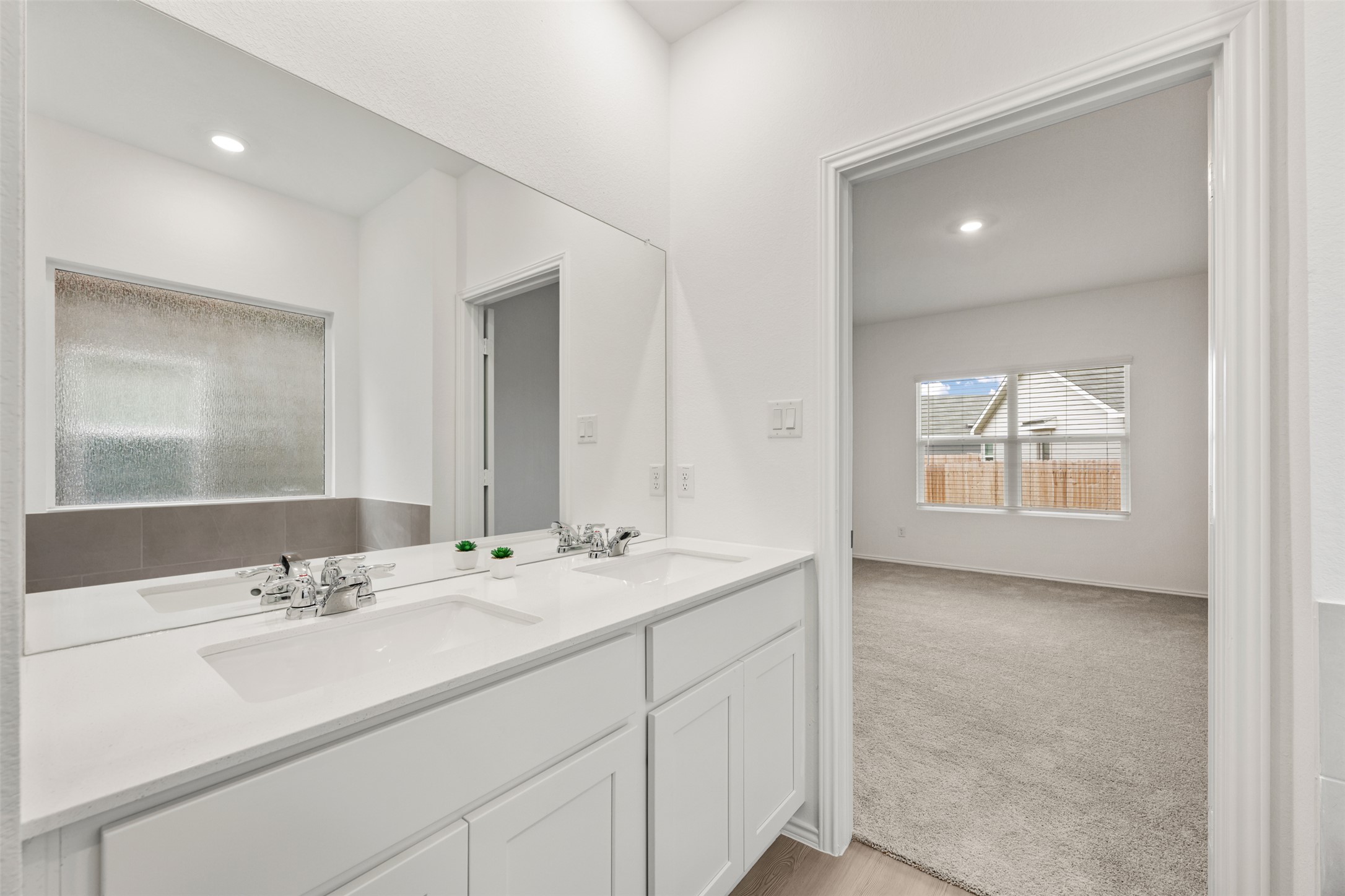 954 Soapstone Pass Maxwell, TX 78656 - Photo 20 of 40 a bathroom with a sink double vanity and a mirror