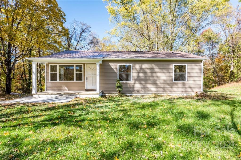 87-j R J R Sayles Road Canton, NC 28716 - Photo 1 of 22 front view of a house with a yard
